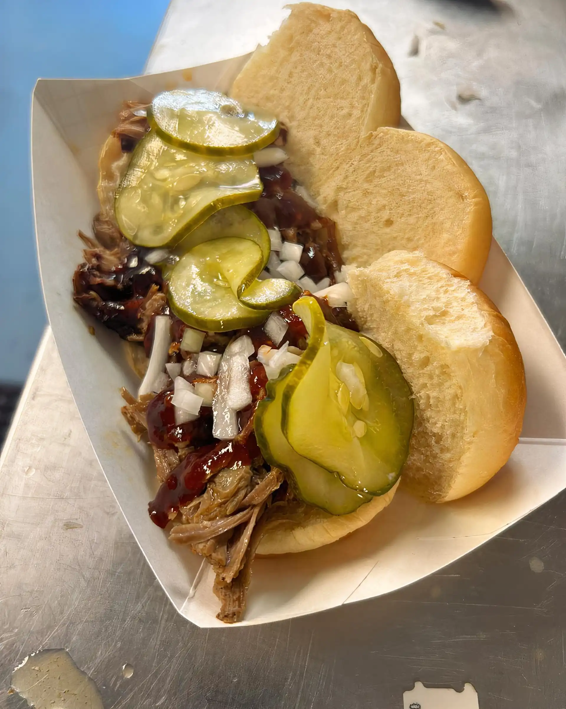 3 Pulled Pork Sliders. Our house slow smoked pulled pork with onions, pickle, and house made BBQ sauce