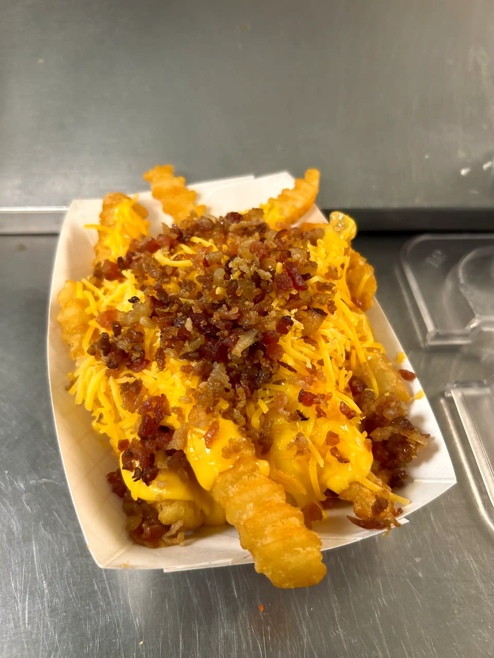 Crinkle Cut French Fries with Bacon Bits, Nacho Cheese and Shredded Cheese