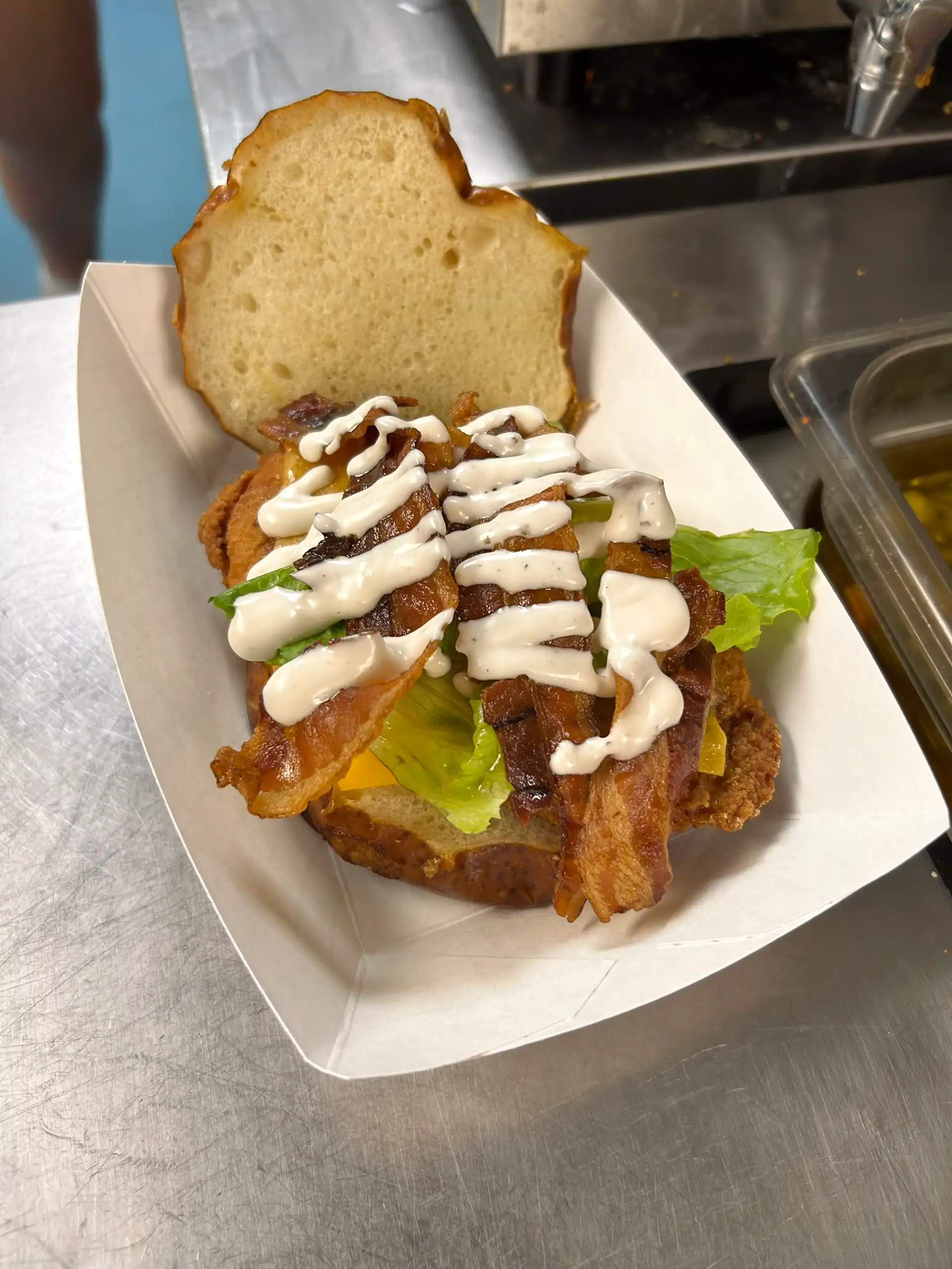 Fried 6 oz. Chicken Breast served on a Pretzel Bun with Bacon Strips, Lettuce, Tomato, Cheddar, and House Made Ranch