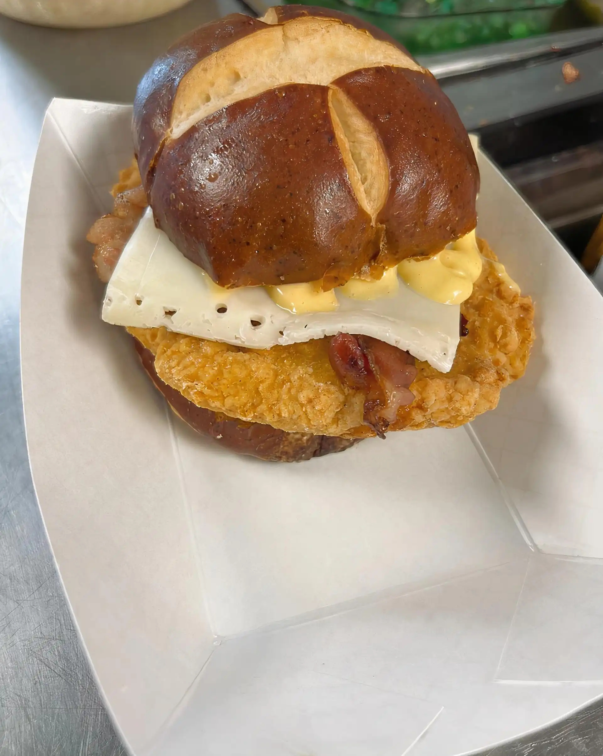 Fried 6 oz. Chicken Breast served on a Pretzel Bun, with Bacon Strips, Swiss Cheese, and House Made Honey Mustard