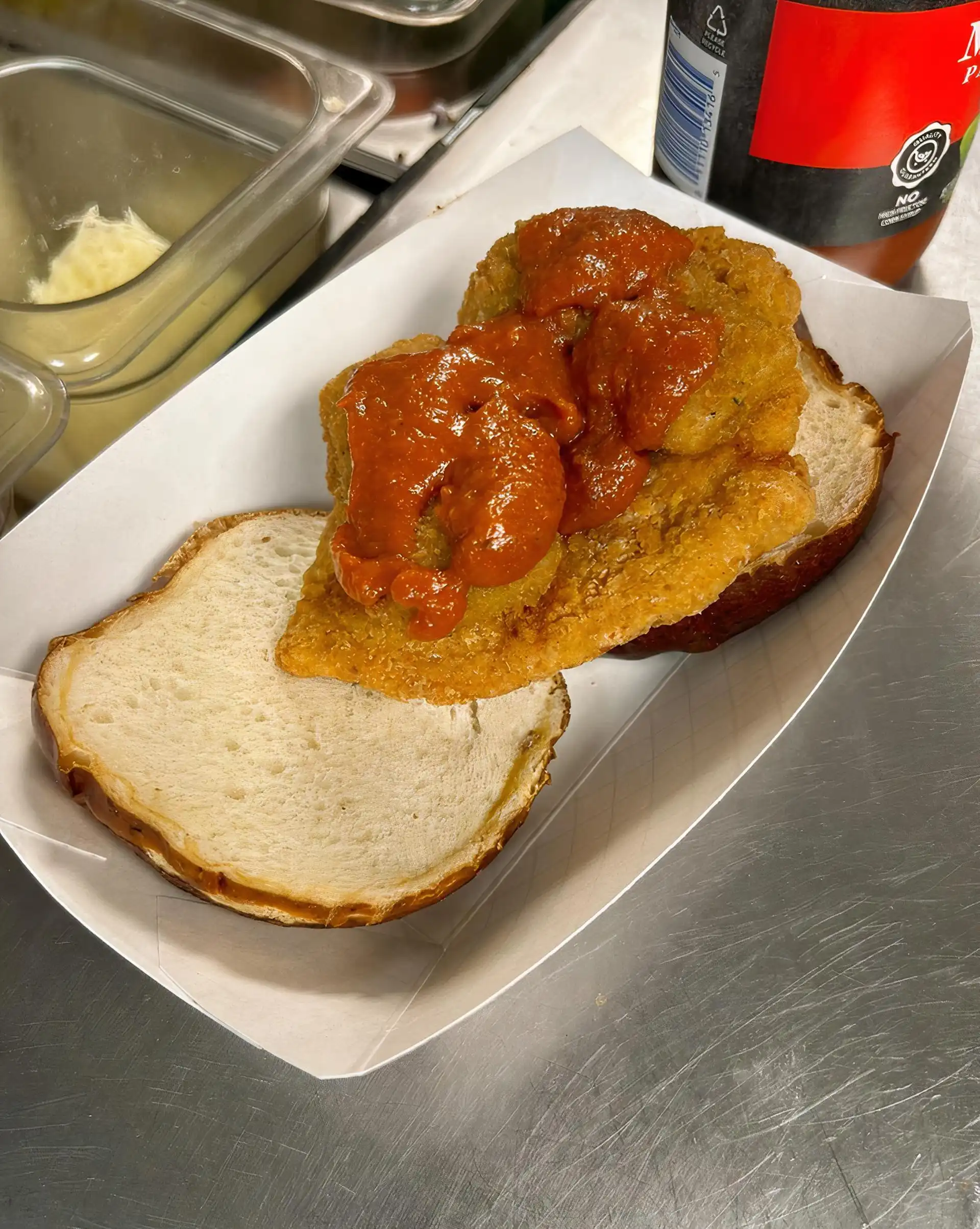 Fried 6 oz. Chicken Breast served on a Pretzel Bun with a Fried Cheese Triangle and Marinara