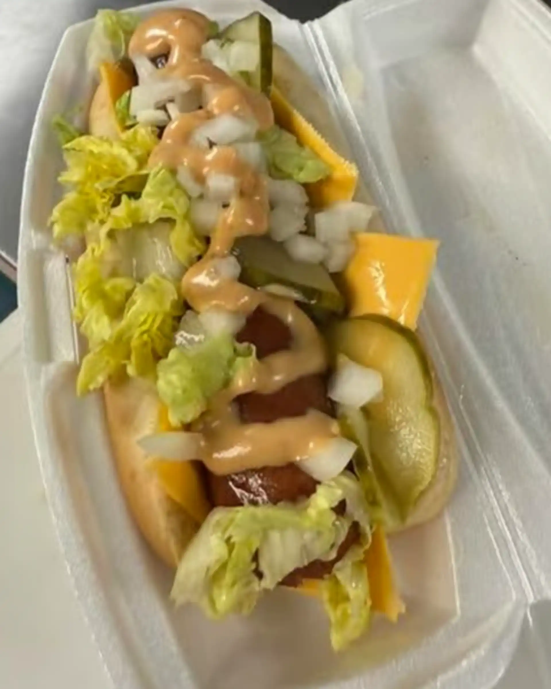 Smoked all beef 1/4 lb. wien with American cheese, lettuce, onion, pickle, and house made mac sauce