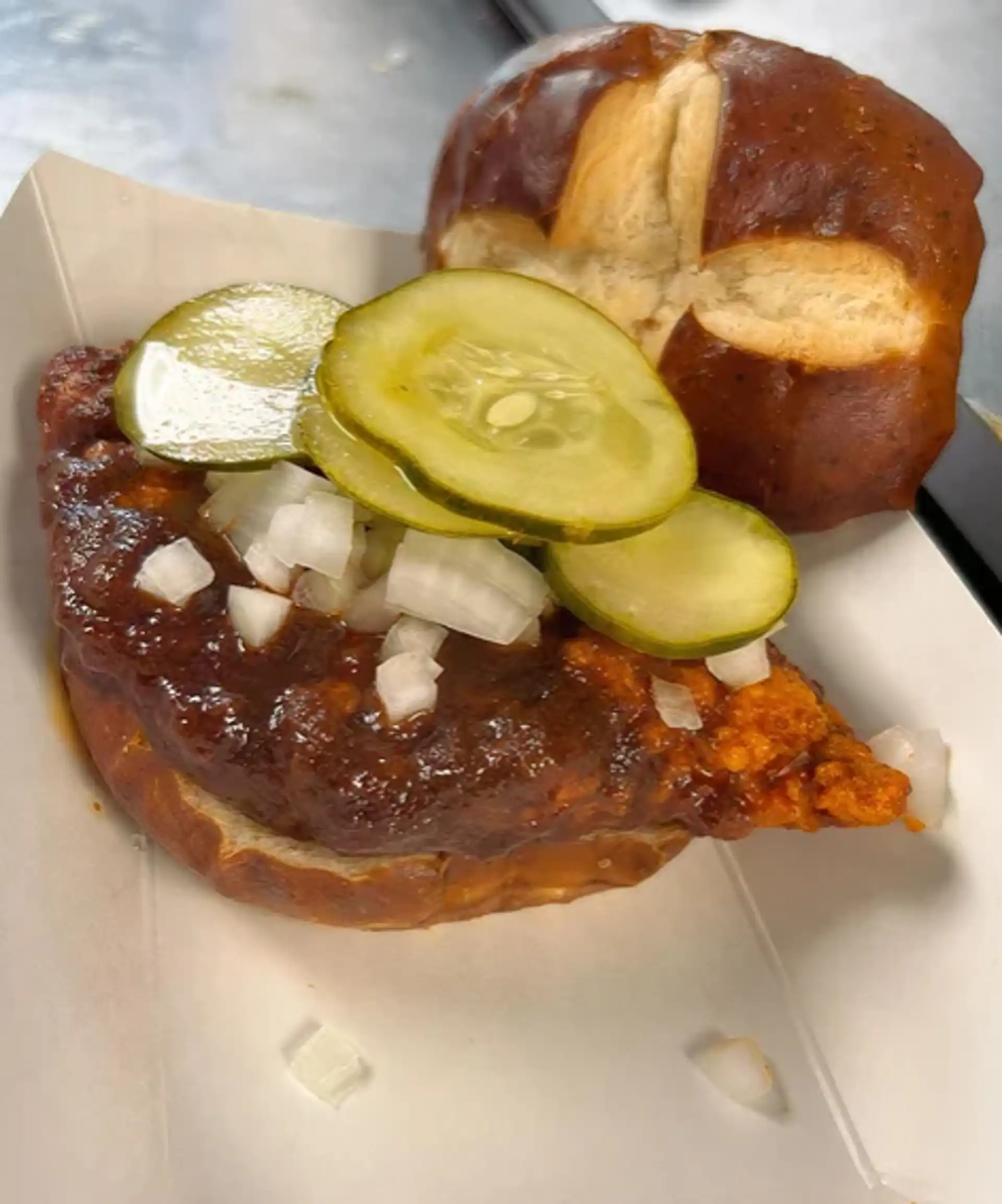 Fried 6 oz. Chicken Breast served on a Pretzel Bun, with Onion, Pickle, Lettuce, and House Made Nashville Hot Sauce